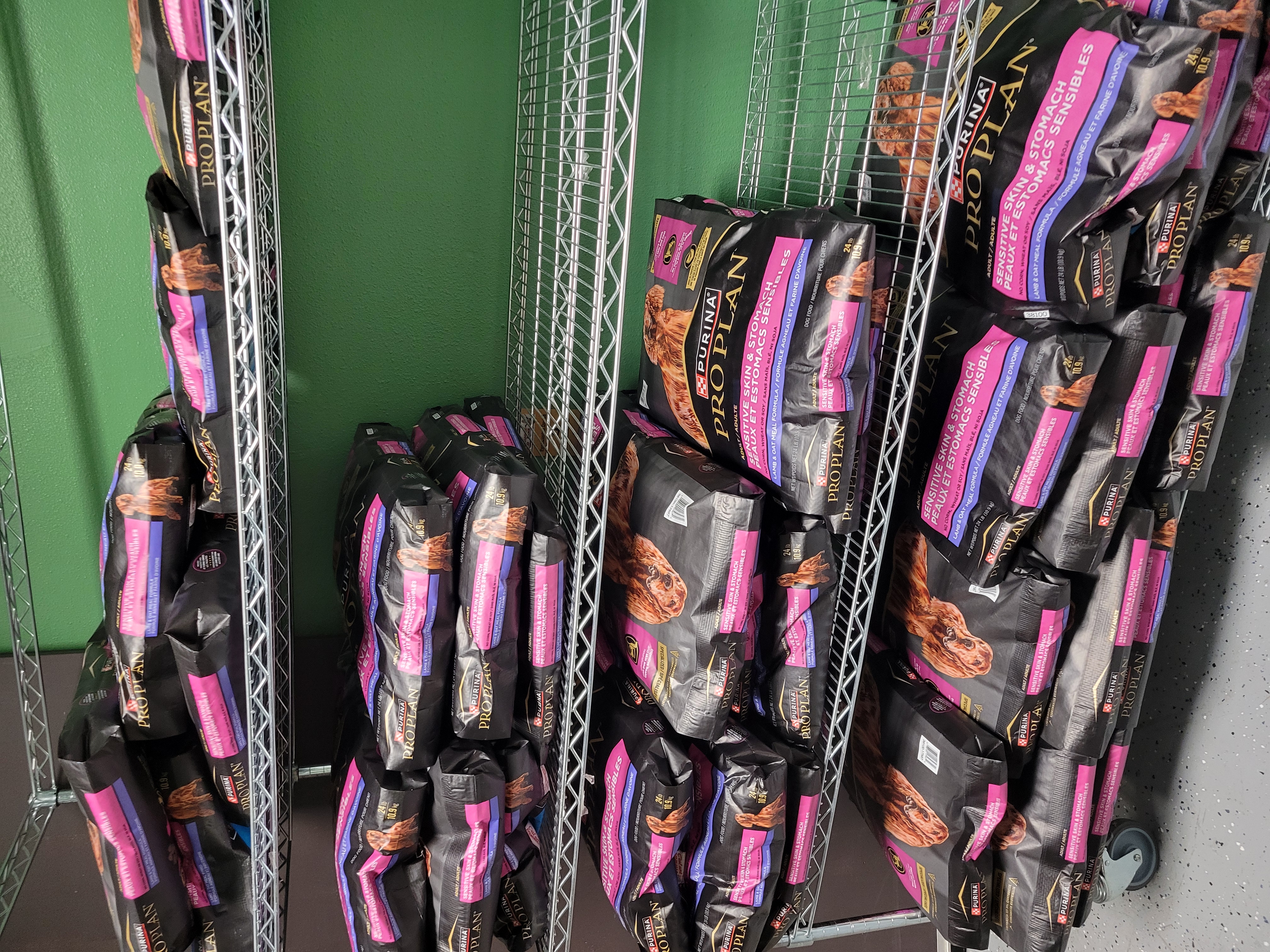 Shelves full of big bags of dog food.